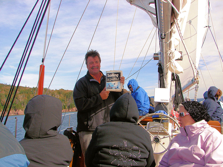 Captain John Bryson Of The 'Amoeba' Amusing Us With His Entertaining Narrative As We Sail The Bras D'or Lakes at Baddeck, Nova Scotia with Amoeba Sailing Tours. Travels, Tours, Photos, Pictures, Images, Information, & Reviews.