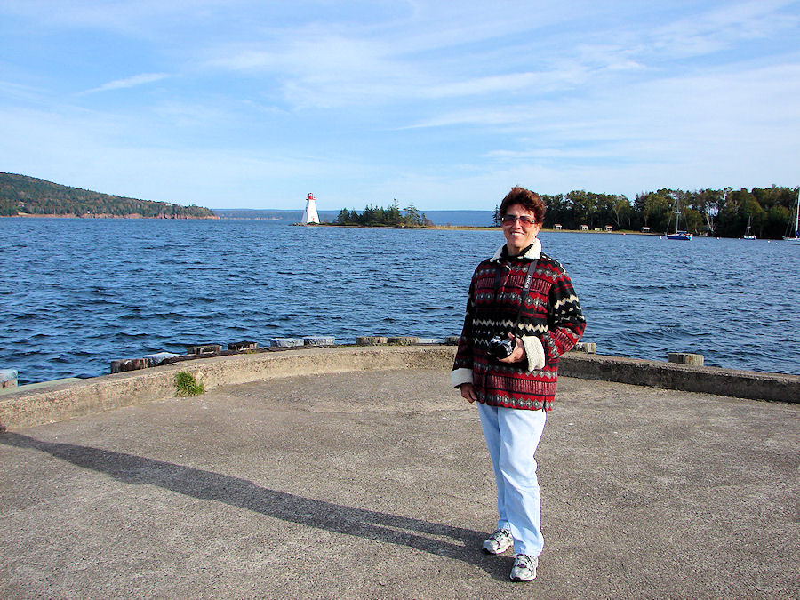 Eve DeLange With Beinn Bhreagh & Kidston Island Light House In Background. From The 'Amoeba' Port As We Sail The Bras D'or Lakes at Baddeck, Nova Scotia with Amoeba Sailing Tours. Travels, Tours, Photos, Pictures, Images, Information, & Reviews.