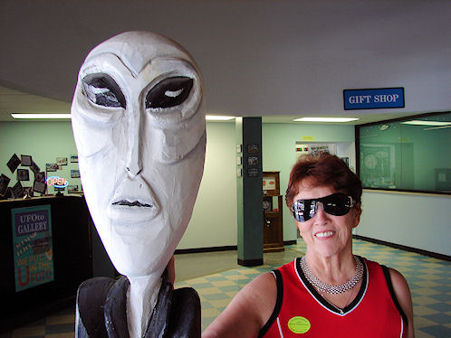 Space Alien Greeting Eve DeLange In Lobby Of The International UFO Museum & Research Center. Roswell, New Mexico. Hikes, Travels, & Tours. Photos, Pictures, Images,& Reviews.