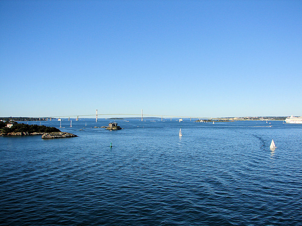 View Of Claiborne Pell Bridge, Commonly Known As The Newport Bridge. Rose Island & Rose Island Lighthouse In Foreground. Newport Harbor, Newport, Rhode Island, United States. Travel, Tours Photos, Pictures, Information, & Reviews.